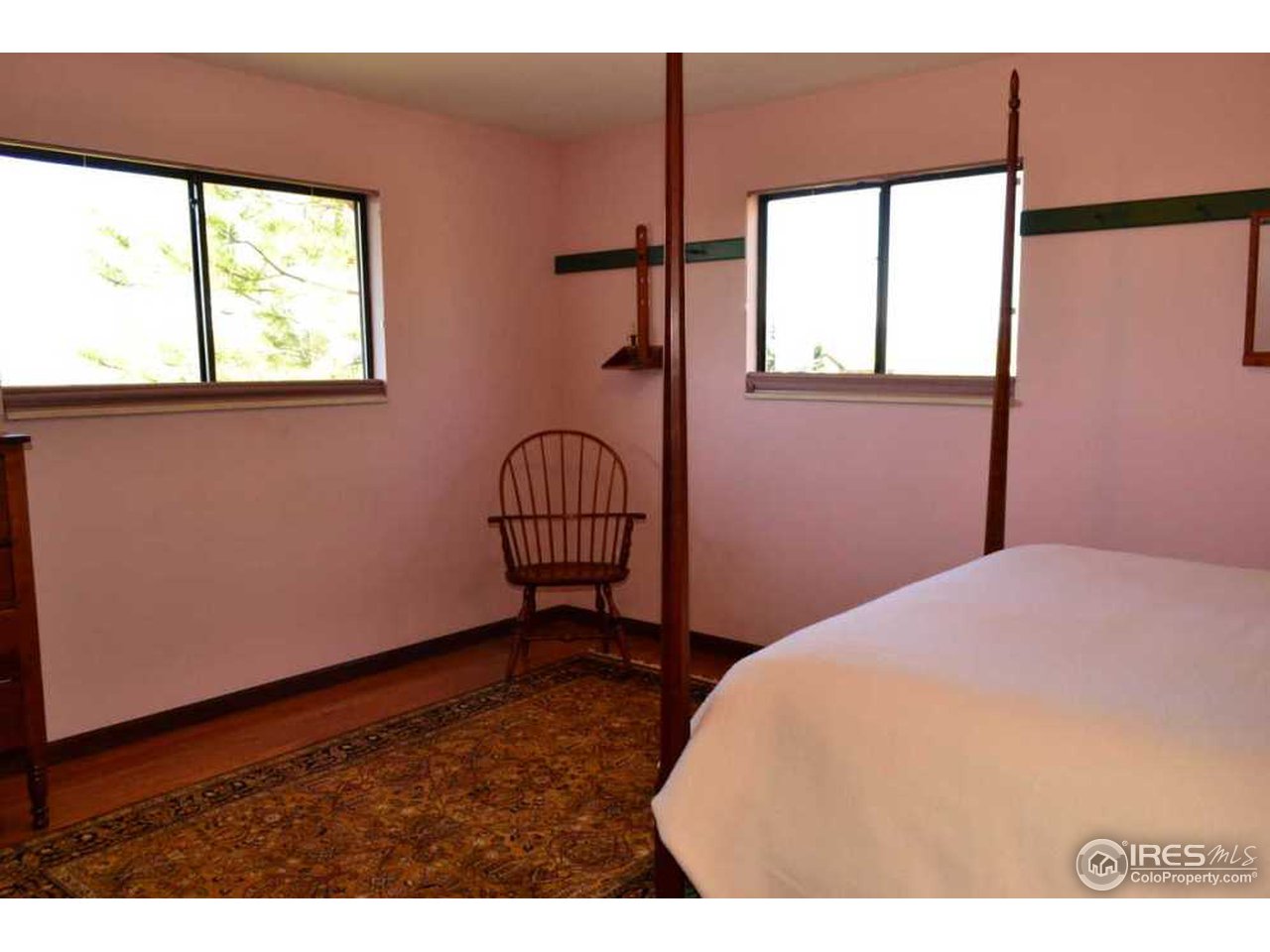 10107 Phillips Road Lafayette, CO 80026 - Photo 13 of 22 a bedroom with a bed and a window