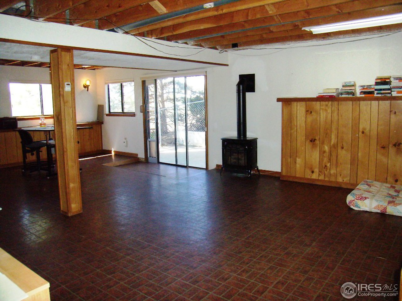10107 Phillips Road Lafayette, CO 80026 - Photo 20 of 22 a view of an empty room with wooden floor and a window