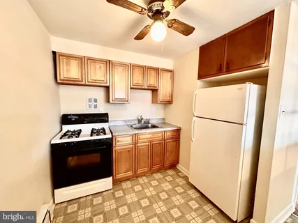 a kitchen with stainless steel appliances granite countertop a refrigerator a stove a sink and a microwave