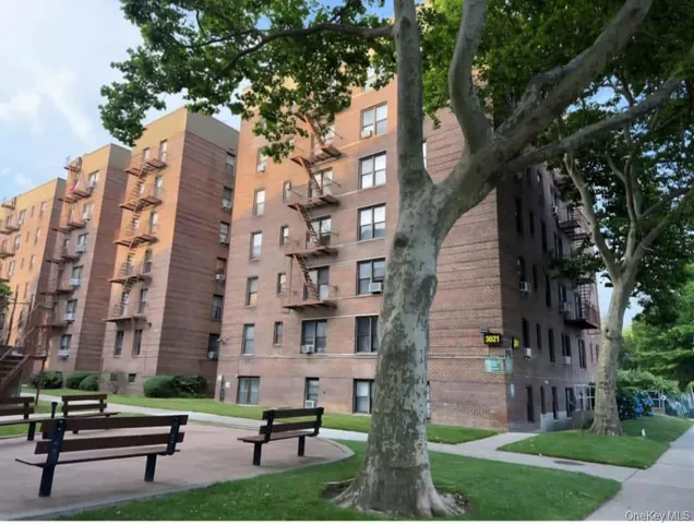 a building view with outdoor seating and trees