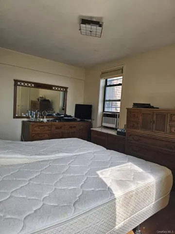a bedroom with a large bed and a dresser