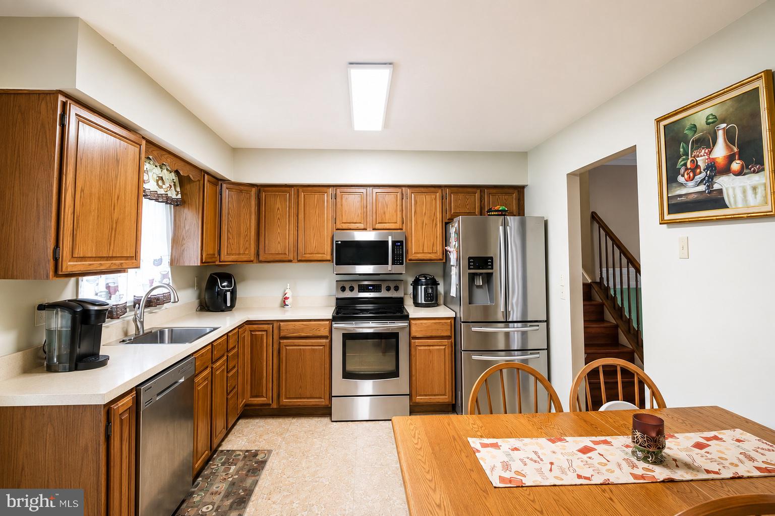 8121 Elizabeth Road Pasadena, MD 21122 - Photo 3 of 27 a kitchen with stainless steel appliances granite countertop a refrigerator and a stove top oven