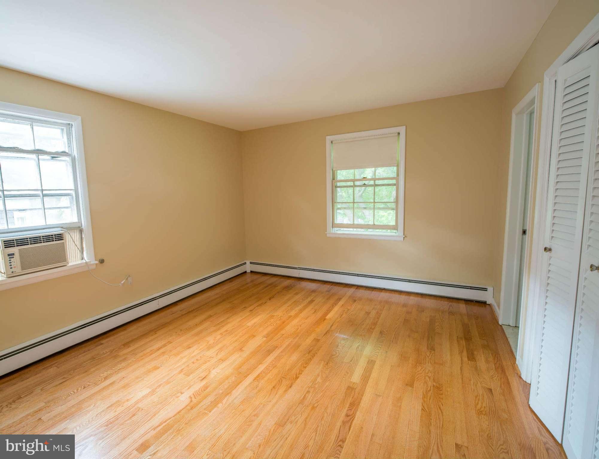 5 Beechdale Road Baltimore, MD 21210 - Photo 13 of 20 a view of empty room with wooden floor and fan