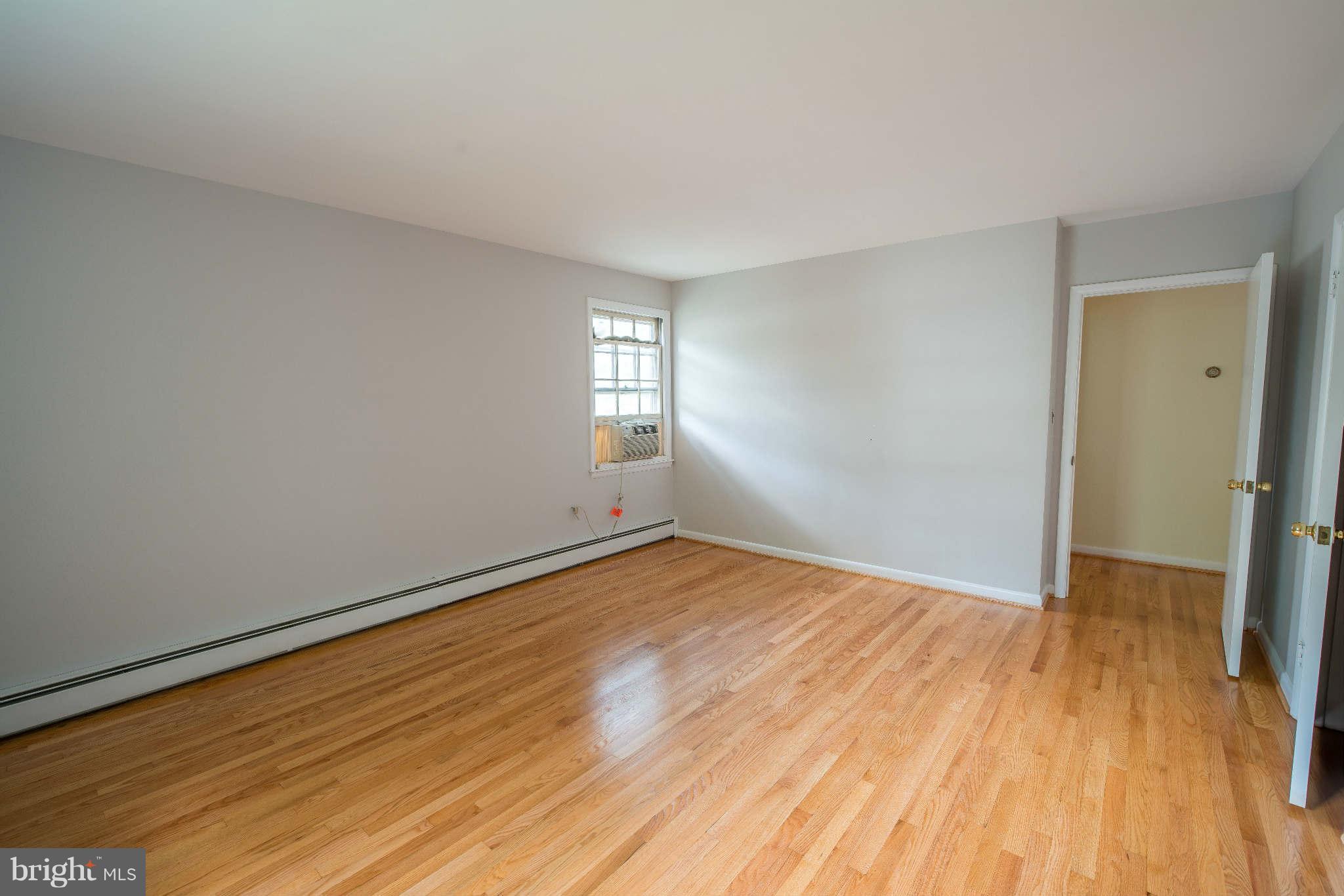 5 Beechdale Road Baltimore, MD 21210 - Photo 14 of 20 a view of empty room with wooden floor and fan