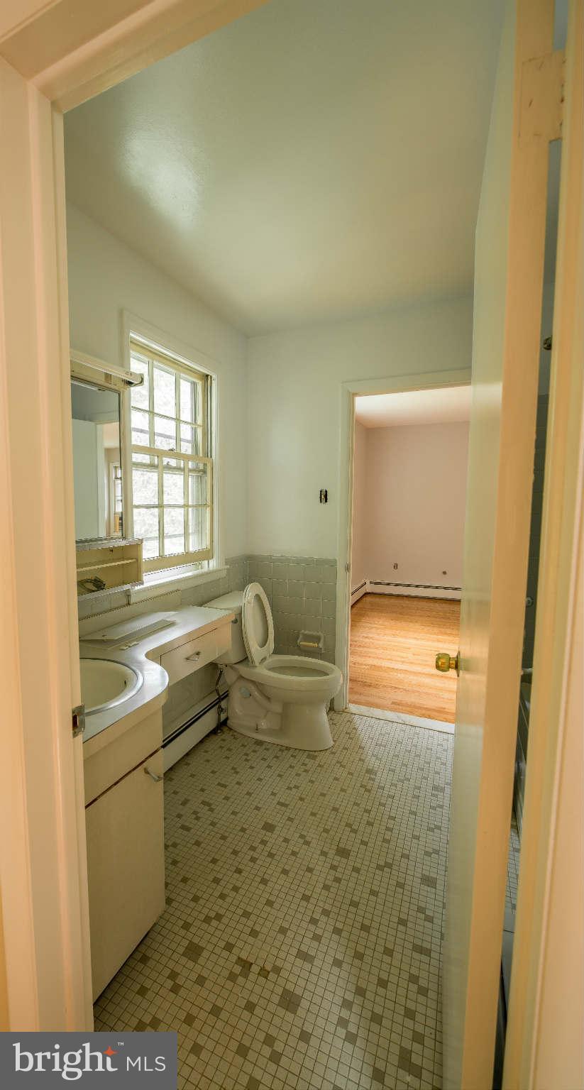 5 Beechdale Road Baltimore, MD 21210 - Photo 15 of 20 a bathroom with a toilet sink and mirror