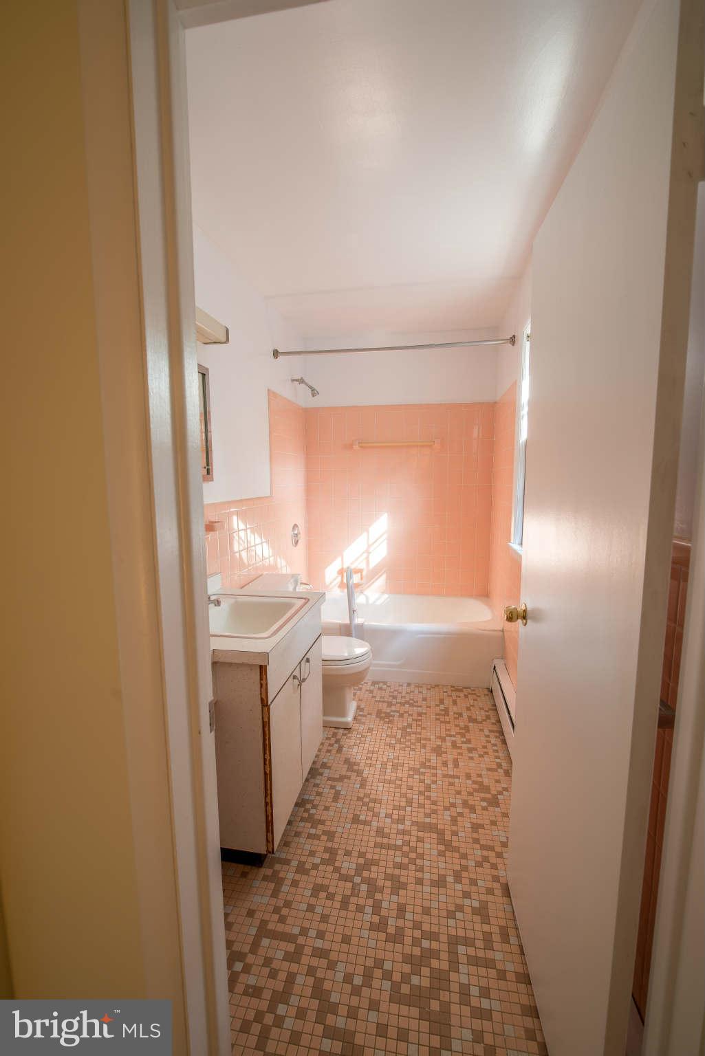 5 Beechdale Road Baltimore, MD 21210 - Photo 16 of 20 a bathroom with a sink and a mirror