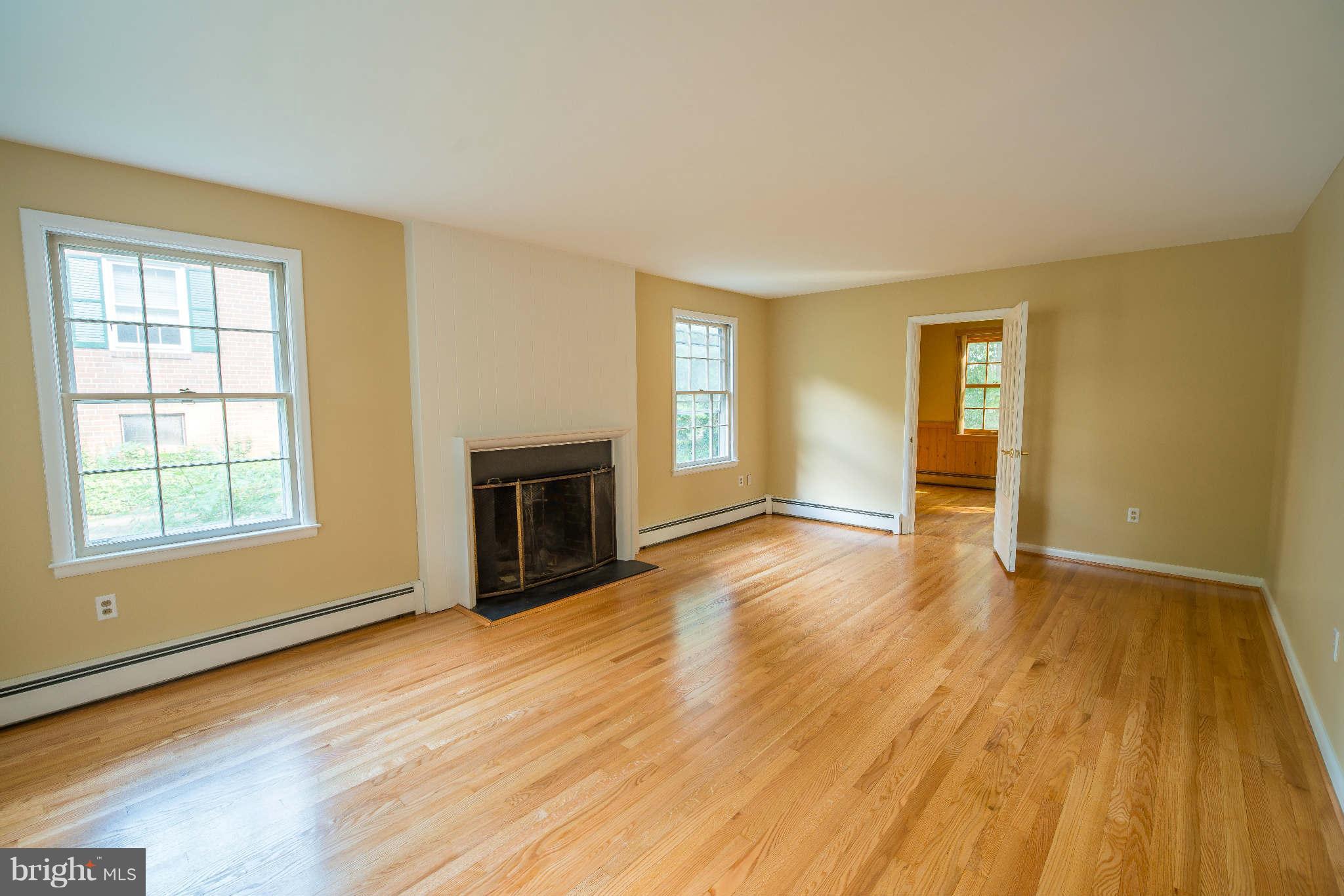5 Beechdale Road Baltimore, MD 21210 - Photo 3 of 20 an empty room with wooden floor and windows