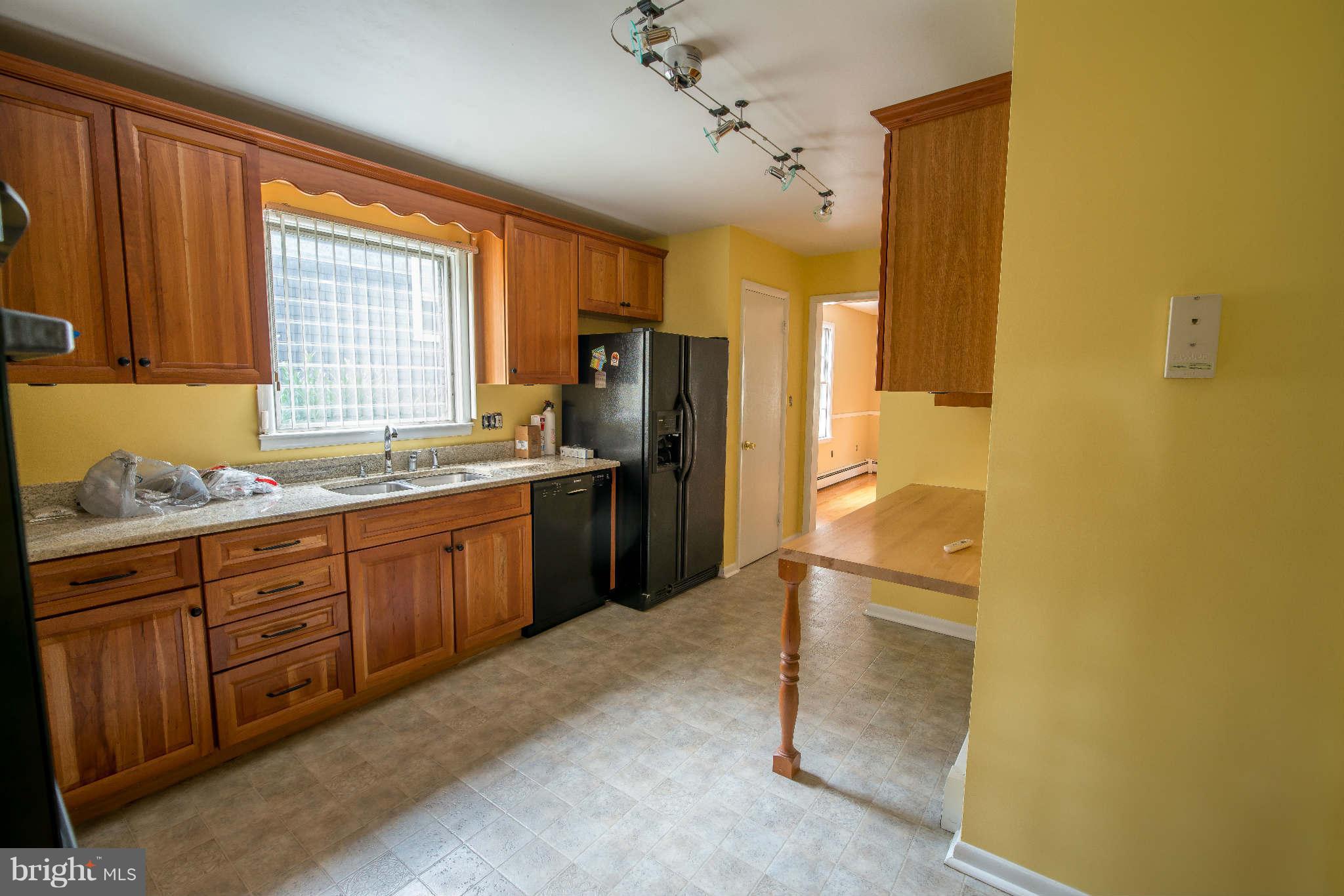 5 Beechdale Road Baltimore, MD 21210 - Photo 4 of 20 a kitchen with granite countertop a refrigerator and a sink