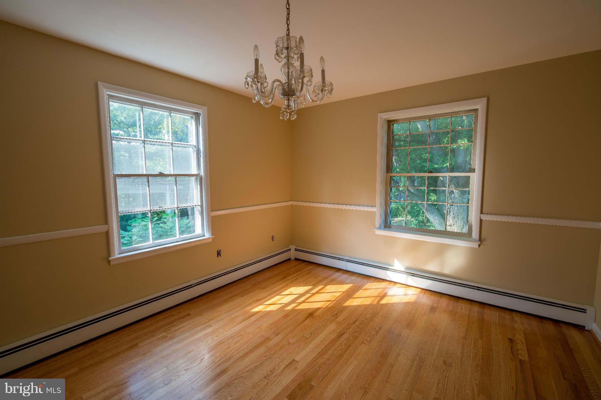 5 Beechdale Road Baltimore, MD 21210 - Photo 6 of 20 a view of an empty room with wooden floor and a window