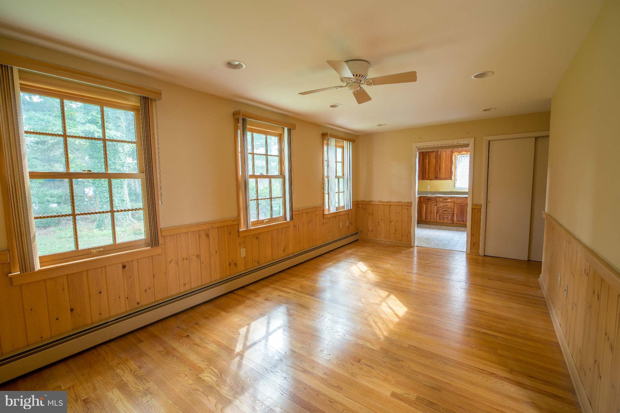 5 Beechdale Road Baltimore, MD 21210 - Photo 8 of 20 a view of an empty room with a window and wooden floor