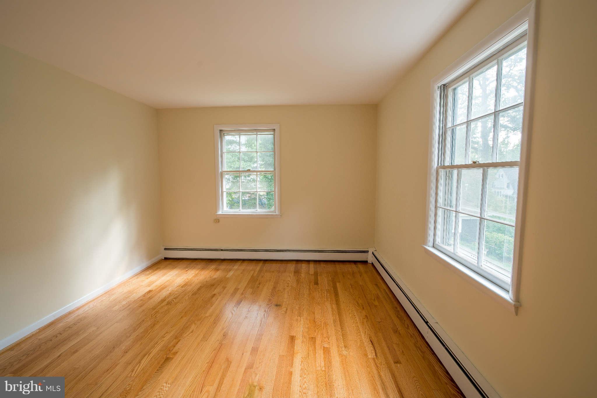 5 Beechdale Road Baltimore, MD 21210 - Photo 9 of 20 an empty room with wooden floor and windows
