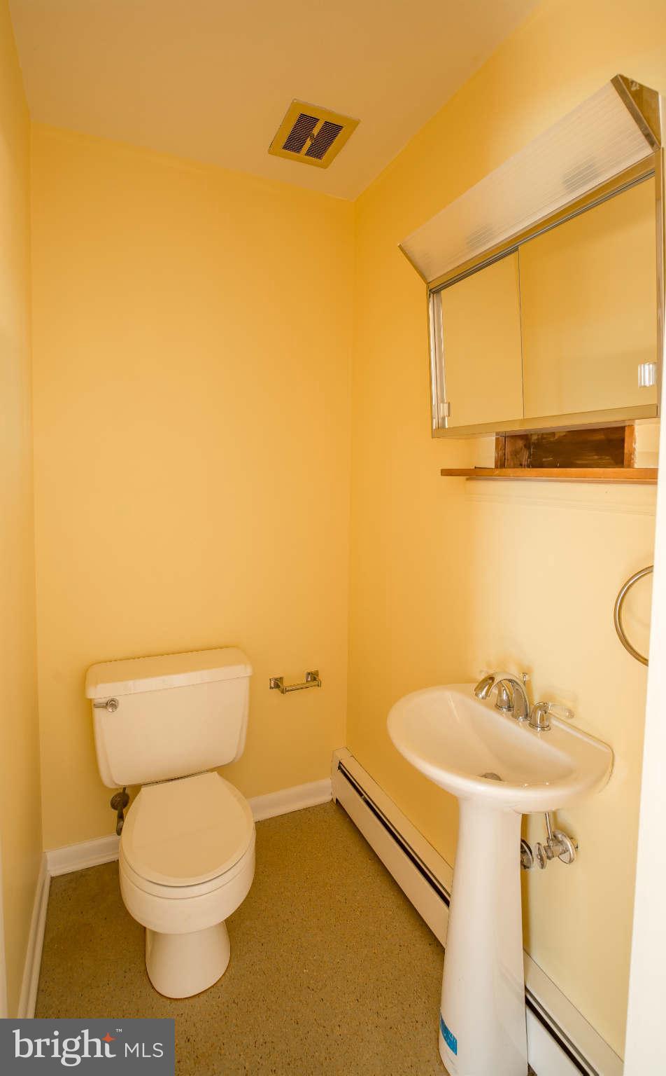 5 Beechdale Road Baltimore, MD 21210 - Photo 10 of 20 a bathroom with a sink a toilet and mirror