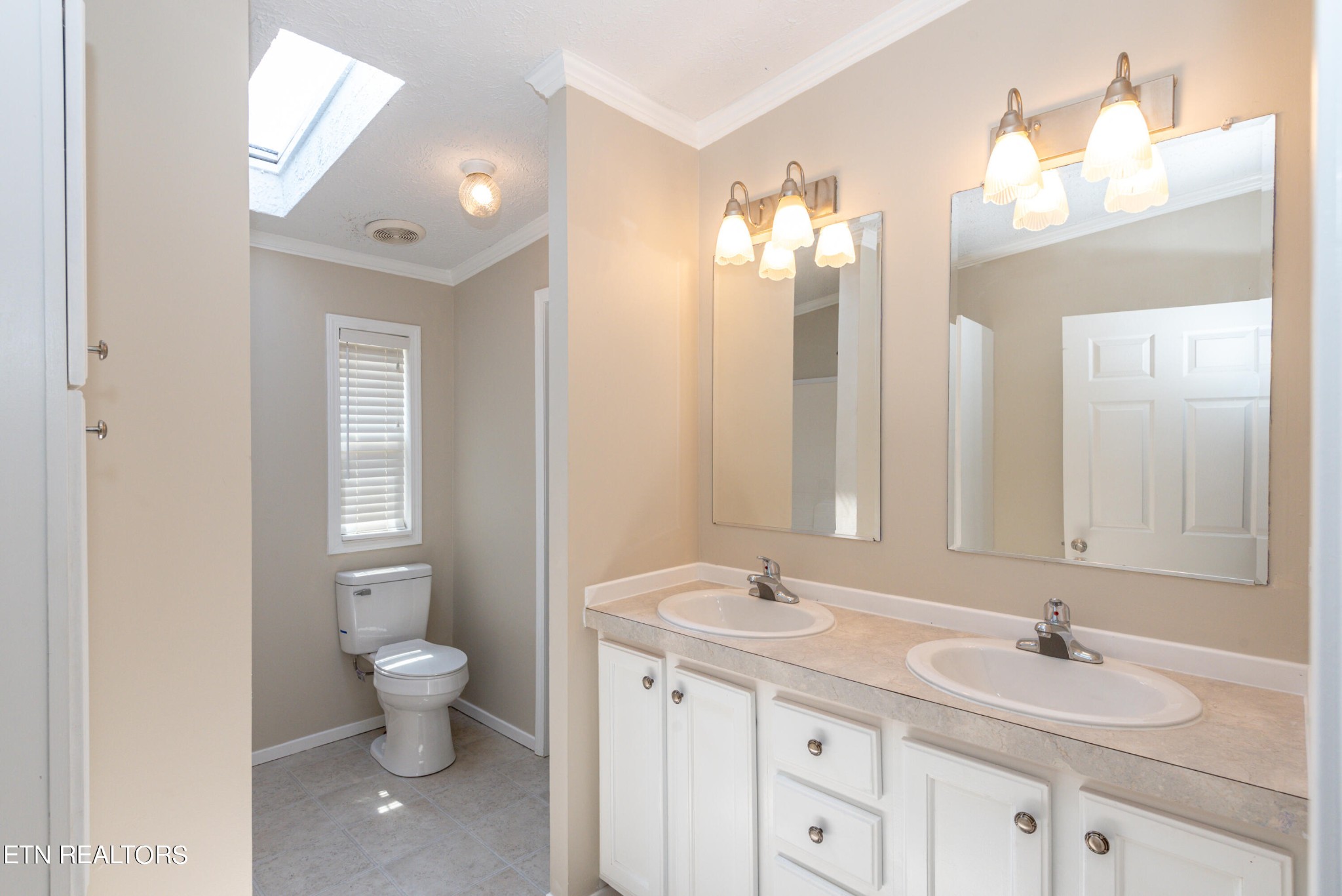 135 Crowder Road Madisonville, TN 37354 - Photo 28 of 39 a bathroom with a double vanity sink a toilet and a mirror