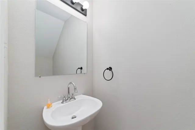 a bathroom with a sink and mirror