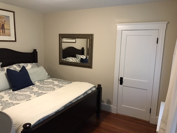 44 Prospect Street Acton, MA 01720 - Photo 16 of 25 a bedroom with a bed and a painting on the wall