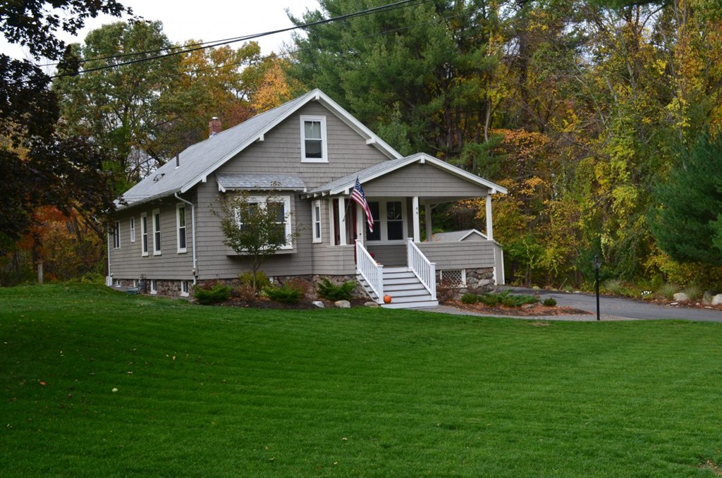 44 Prospect Street Acton, MA 01720 - Photo 2 of 25 a front view of a house with a yard and trees