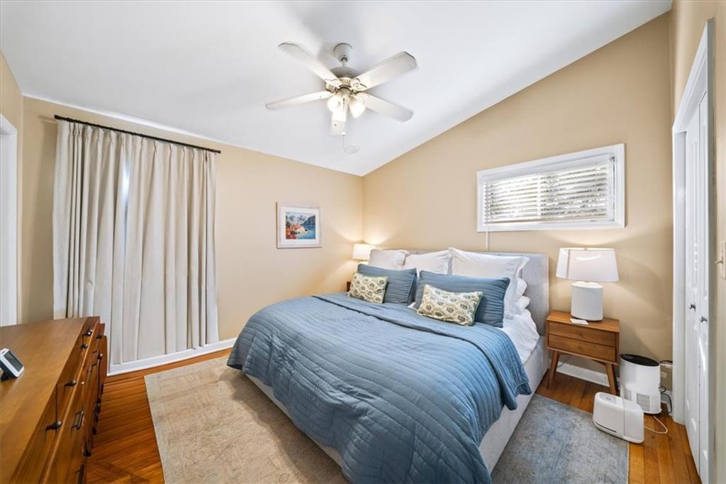109 Spruell Springs Road Atlanta, GA 30342 - Photo 11 of 34 a bedroom with a bed and a chandelier
