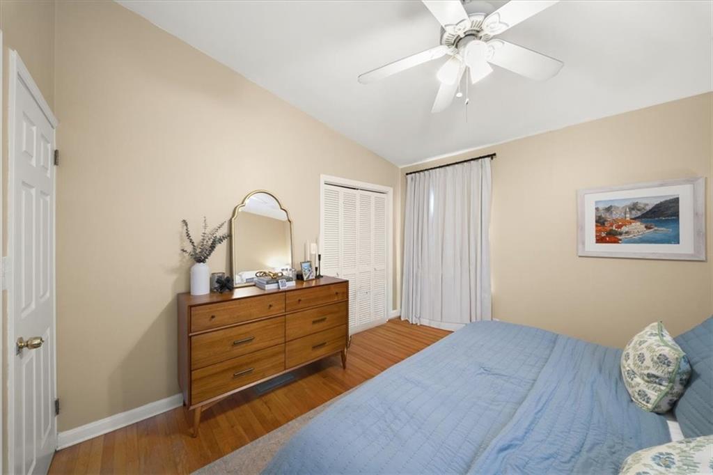 109 Spruell Springs Road Atlanta, GA 30342 - Photo 13 of 34 a bedroom with a bed and a chandelier