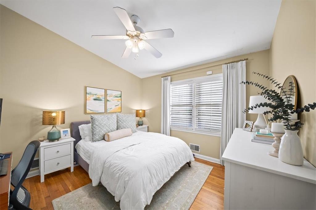 109 Spruell Springs Road Atlanta, GA 30342 - Photo 17 of 34 a bedroom with a bed and a chandelier