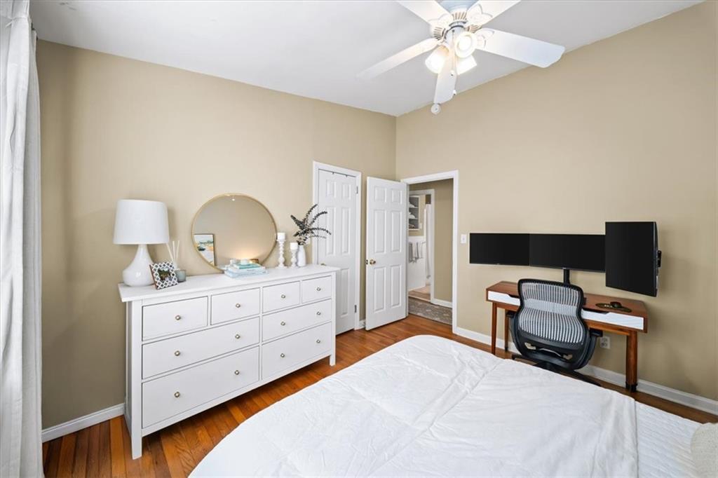109 Spruell Springs Road Atlanta, GA 30342 - Photo 18 of 34 a bedroom with a bed and a chandelier