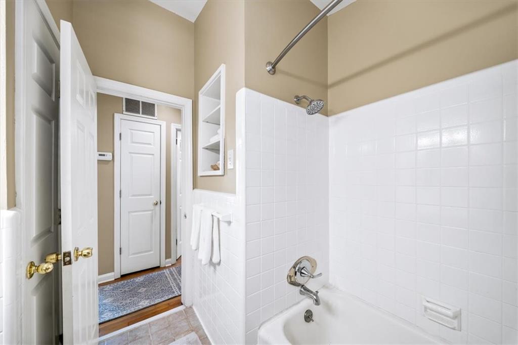 109 Spruell Springs Road Atlanta, GA 30342 - Photo 20 of 34 a bathroom with a shower and a tub
