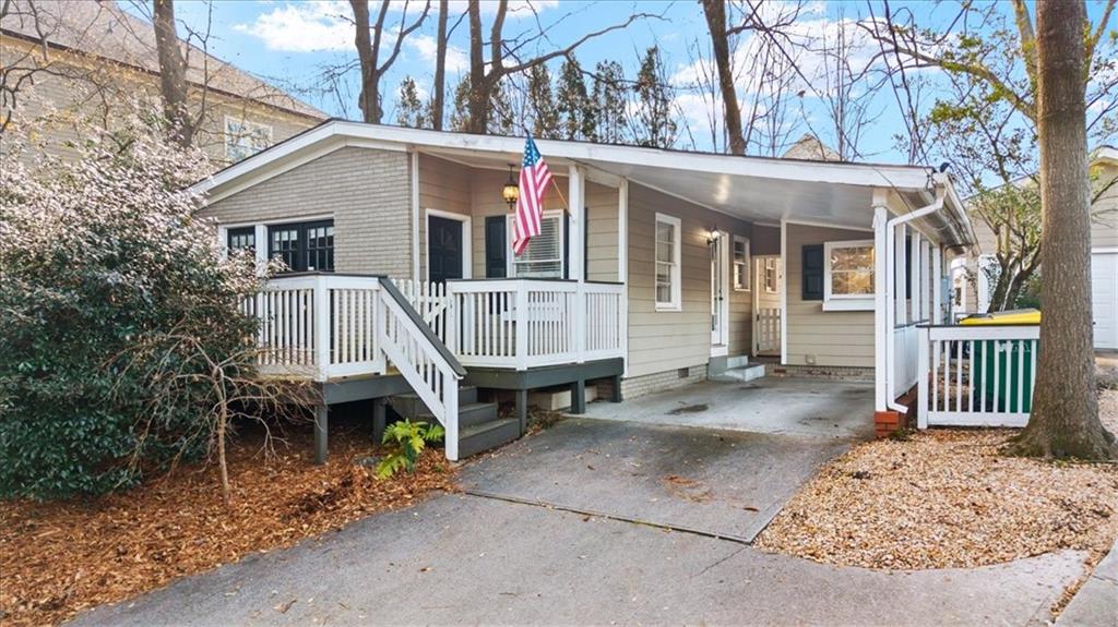 109 Spruell Springs Road Atlanta, GA 30342 - Photo 2 of 34 a view of a house with a wooden deck and a yard