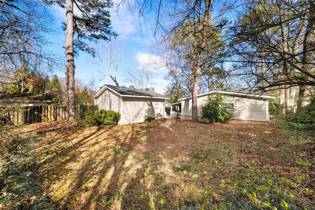 109 Spruell Springs Road Atlanta, GA 30342 - Photo 29 of 34 a view of a house with a yard and garage