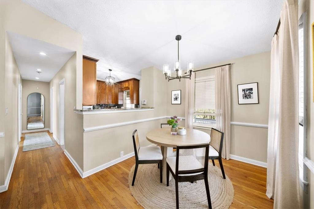 109 Spruell Springs Road Atlanta, GA 30342 - Photo 7 of 34 a view of a dining room with furniture and wooden floor