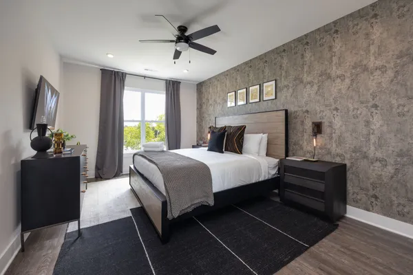 a bedroom with a bed and a large window