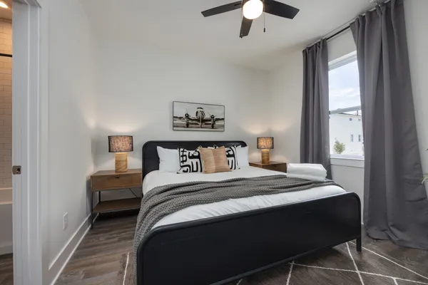 a spacious bedroom with a bed and a potted plant