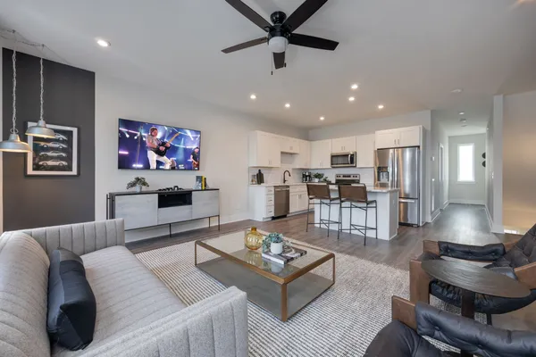 a living room with furniture potted plant and a flat screen tv