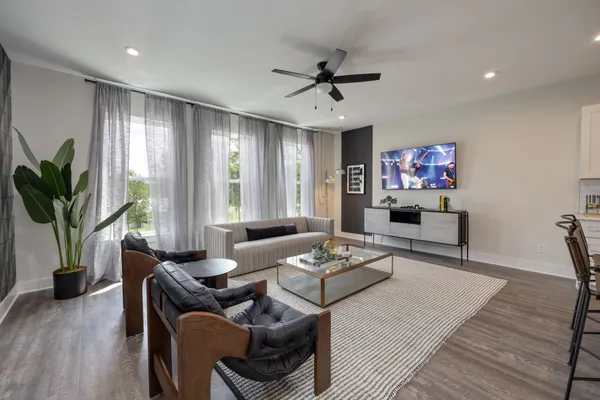 a living room with furniture and a wooden floor