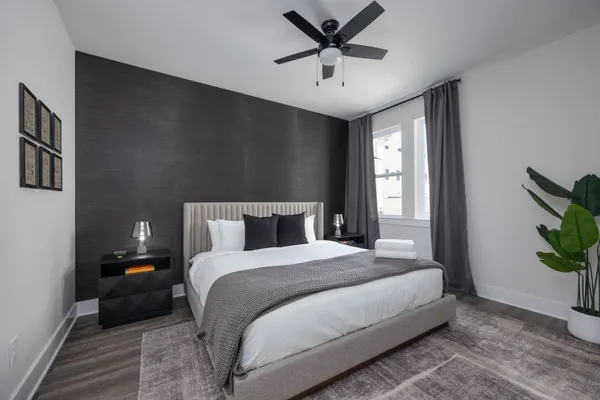 a bedroom with a bed and a chandelier