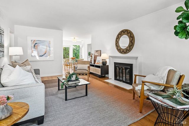 a living room with furniture a rug and a fireplace