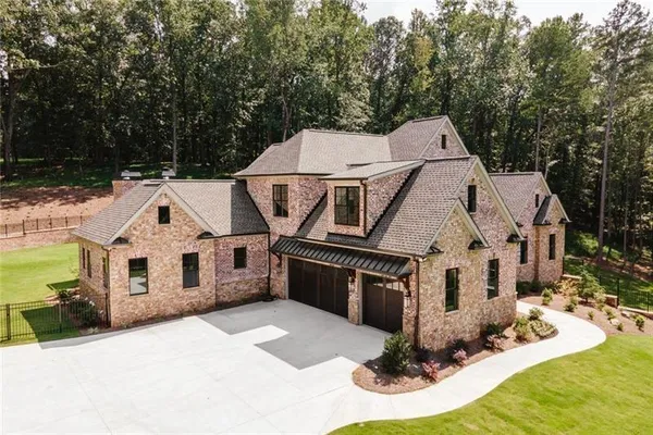 an aerial view of a house with a big yard