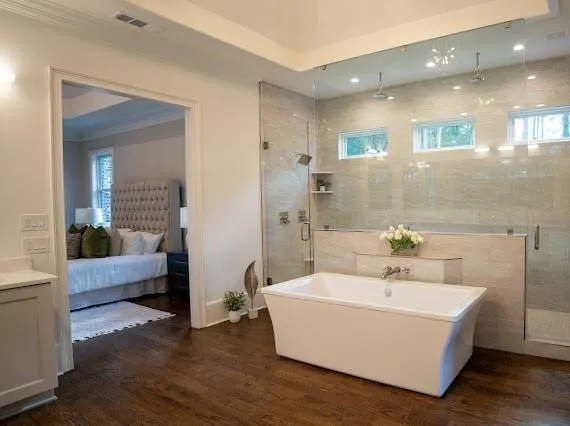 a kitchen with a dining table chairs stainless steel appliances and cabinets