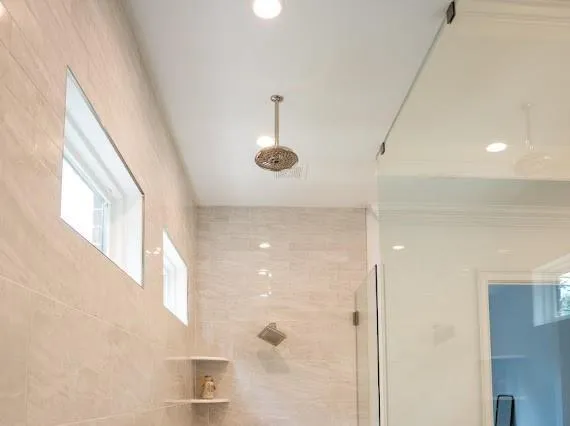 a spacious bathroom with a double vanity sink a toilet and a mirror