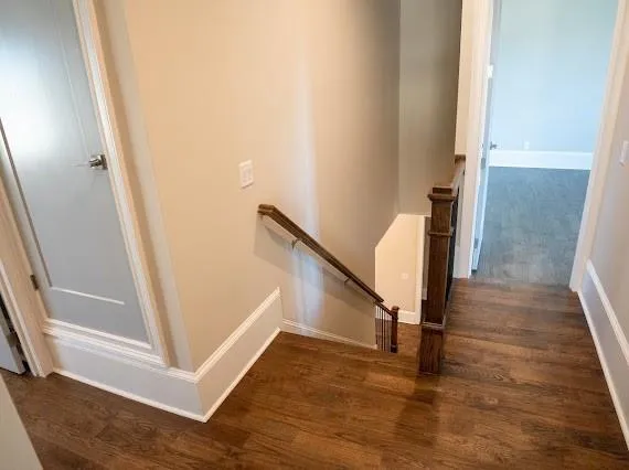 a view of an empty room with windows and chandelier