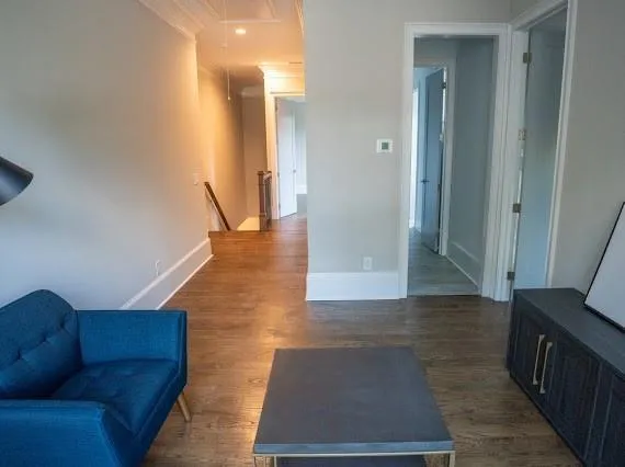 a view of empty room with wooden floor and ceiling fan