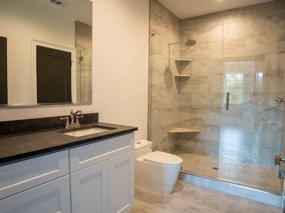 Undisclosed Address Athens, GA 30607 - Photo 51 of 85 a bathroom with a granite countertop sink a toilet and shower