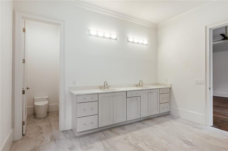 Undisclosed Address Athens, GA 30607 - Photo 64 of 85 a spacious bathroom with a double vanity sink a toilet and a mirror