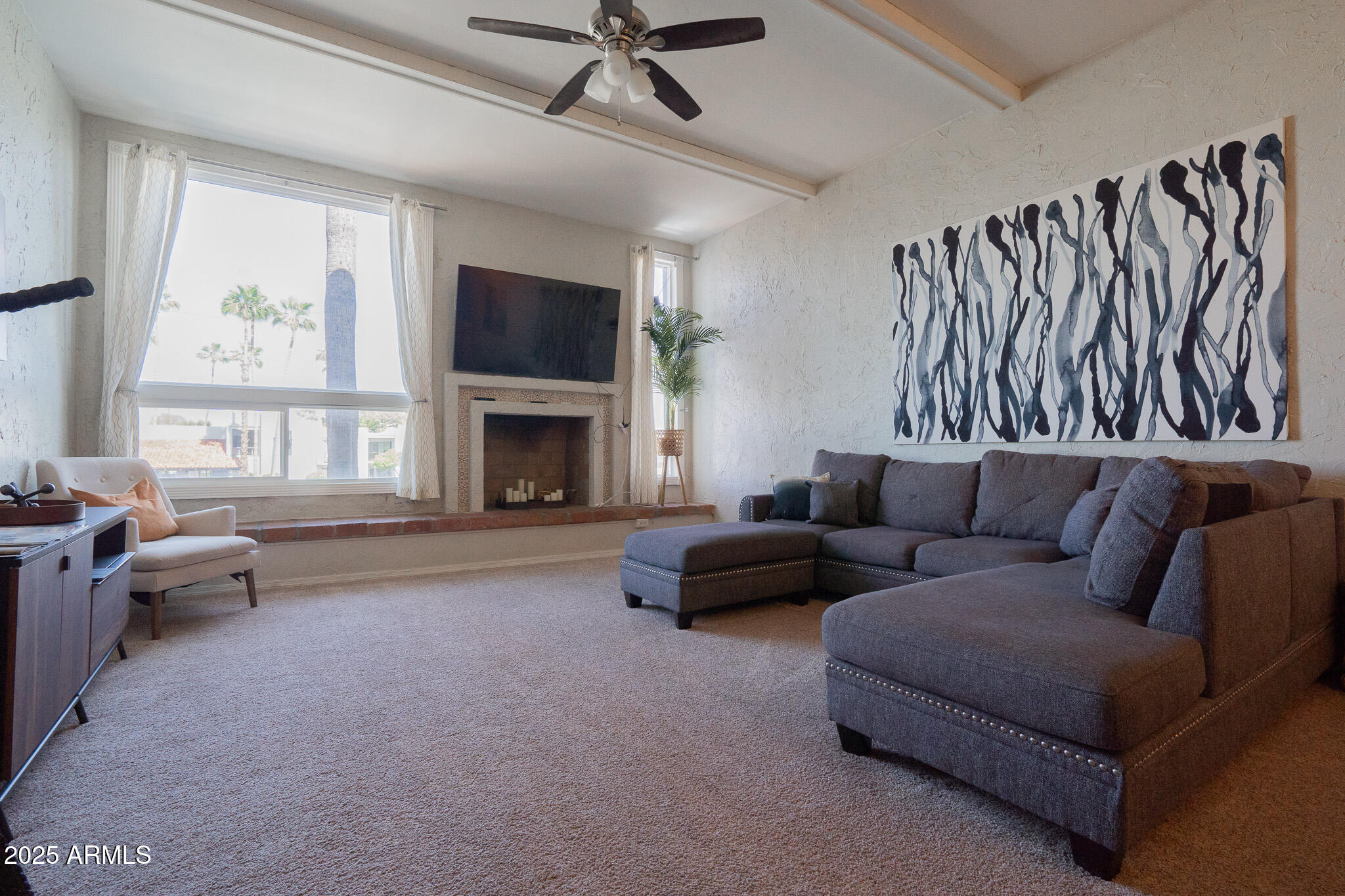3314 North 68th Street, Unit 201 Scottsdale, AZ 85251 - Photo 11 of 29 a living room with furniture fireplace and a flat screen tv