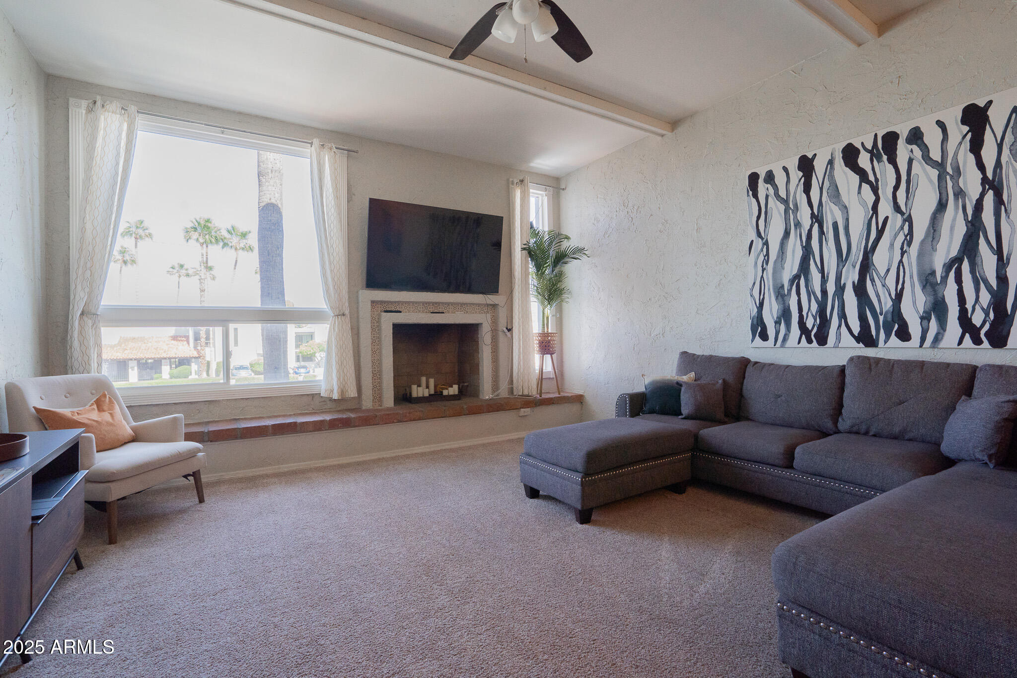 3314 North 68th Street, Unit 201 Scottsdale, AZ 85251 - Photo 15 of 29 a living room with furniture a flat screen tv and a fireplace