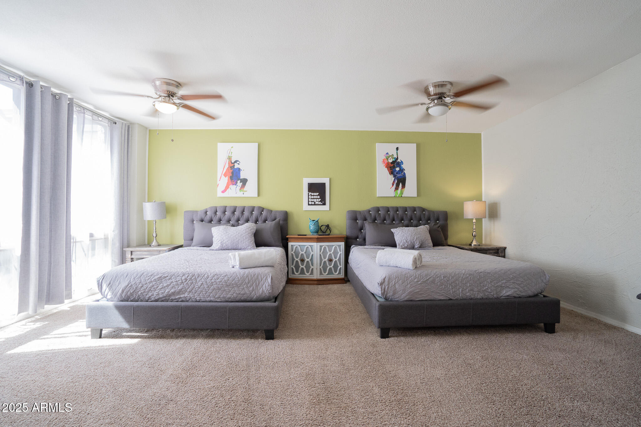 3314 North 68th Street, Unit 201 Scottsdale, AZ 85251 - Photo 18 of 29 a spacious bedroom with a bed and a chandelier