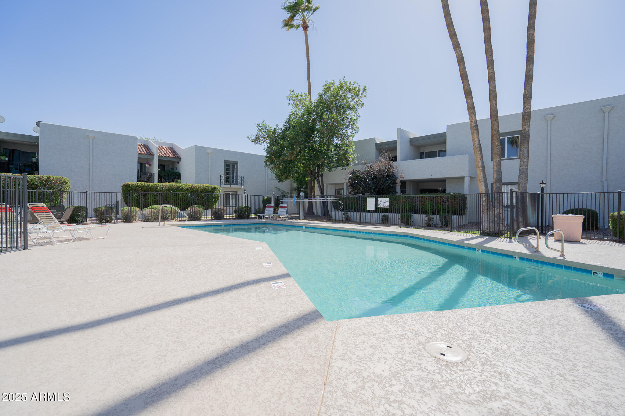 3314 North 68th Street, Unit 201 Scottsdale, AZ 85251 - Photo 27 of 29 a swimming pool with outdoor seating and yard