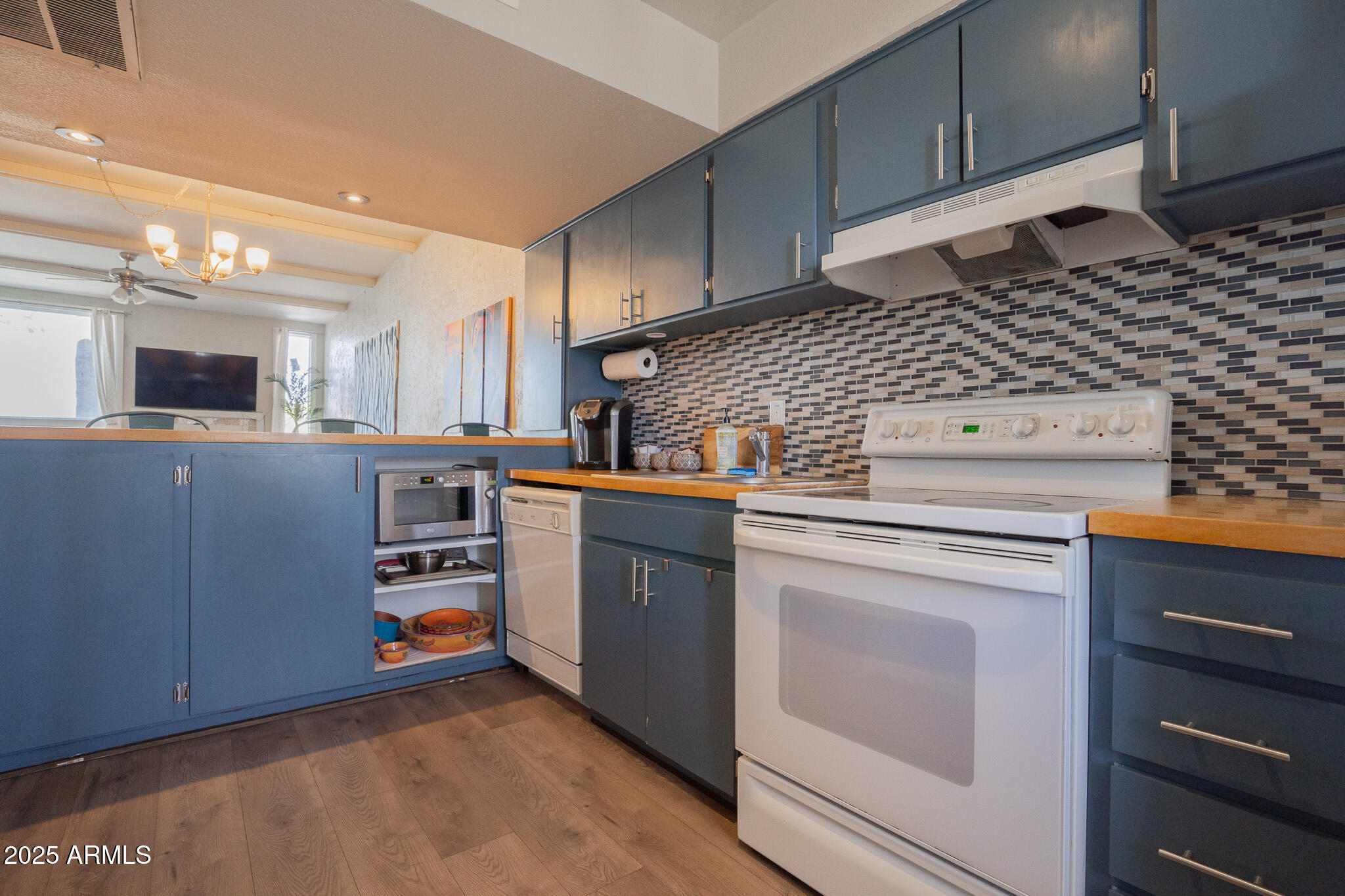 3314 North 68th Street, Unit 201 Scottsdale, AZ 85251 - Photo 9 of 29 a kitchen with stainless steel appliances granite countertop a stove and a refrigerator
