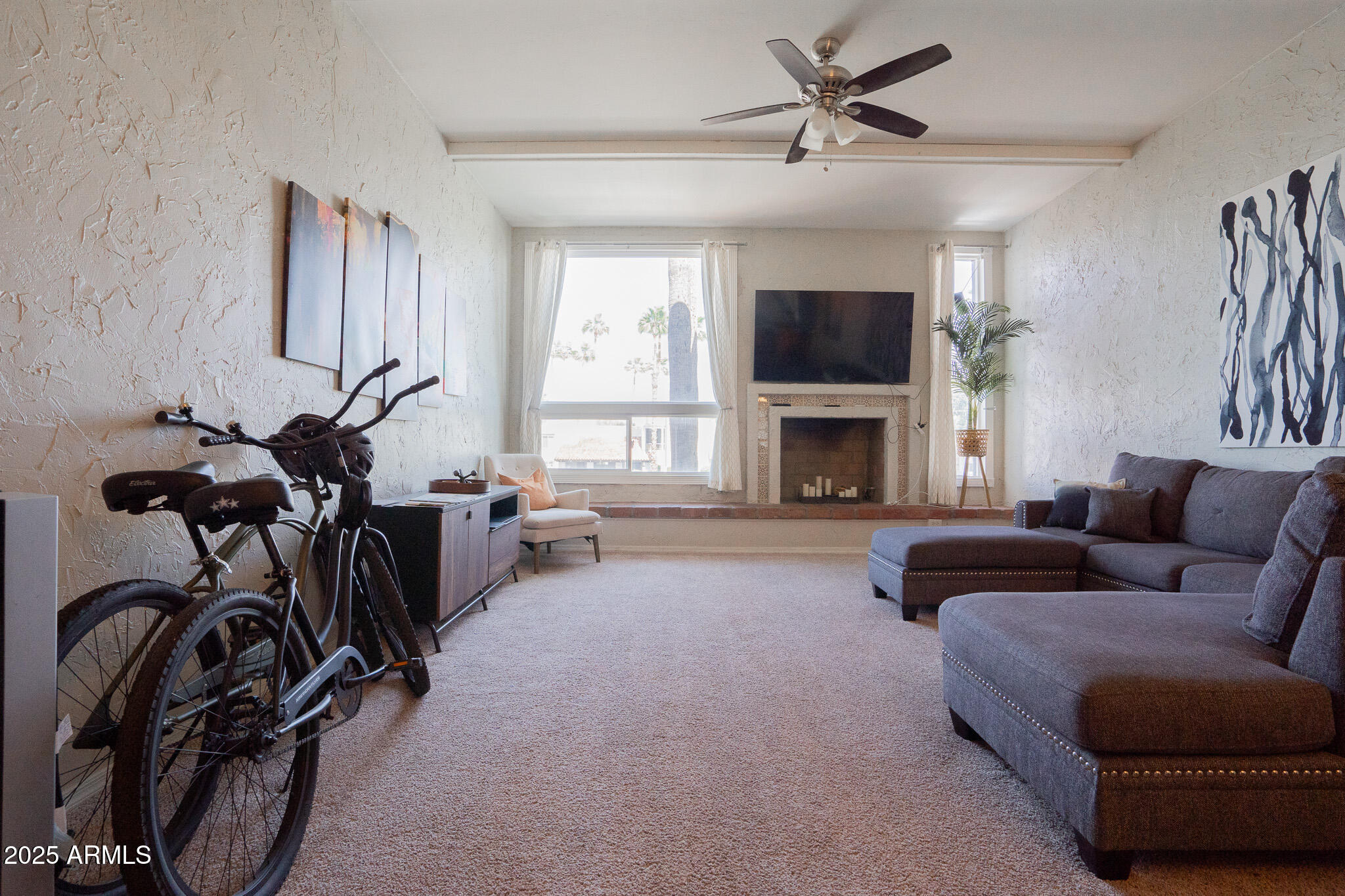 3314 North 68th Street, Unit 201 Scottsdale, AZ 85251 - Photo 10 of 29 a living room with furniture a flat screen tv and a fireplace