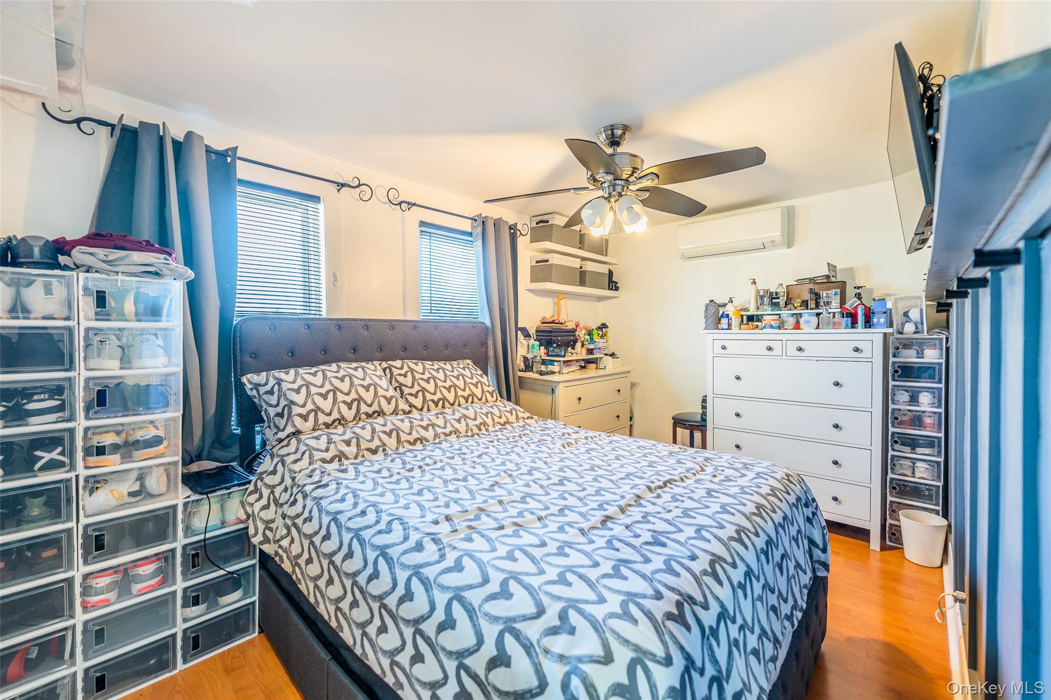 89-32 90th Street Queens, NY 11421 - Photo 13 of 33 Bedroom with light wood finished floors, ceiling fan, and a wall mounted mini split