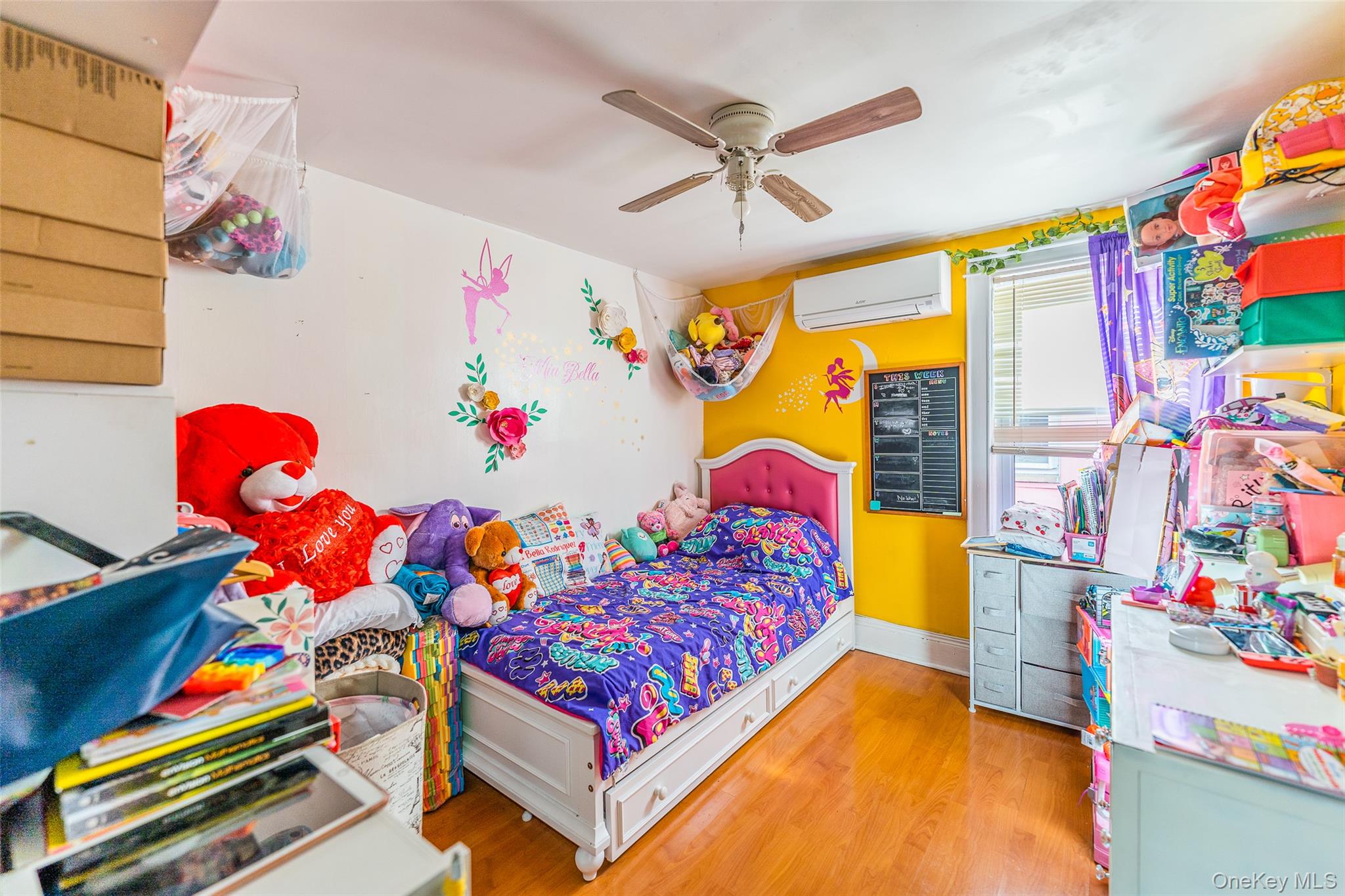 89-32 90th Street Queens, NY 11421 - Photo 16 of 33 Bedroom with light wood-type flooring, a ceiling fan, and a wall mounted mini split