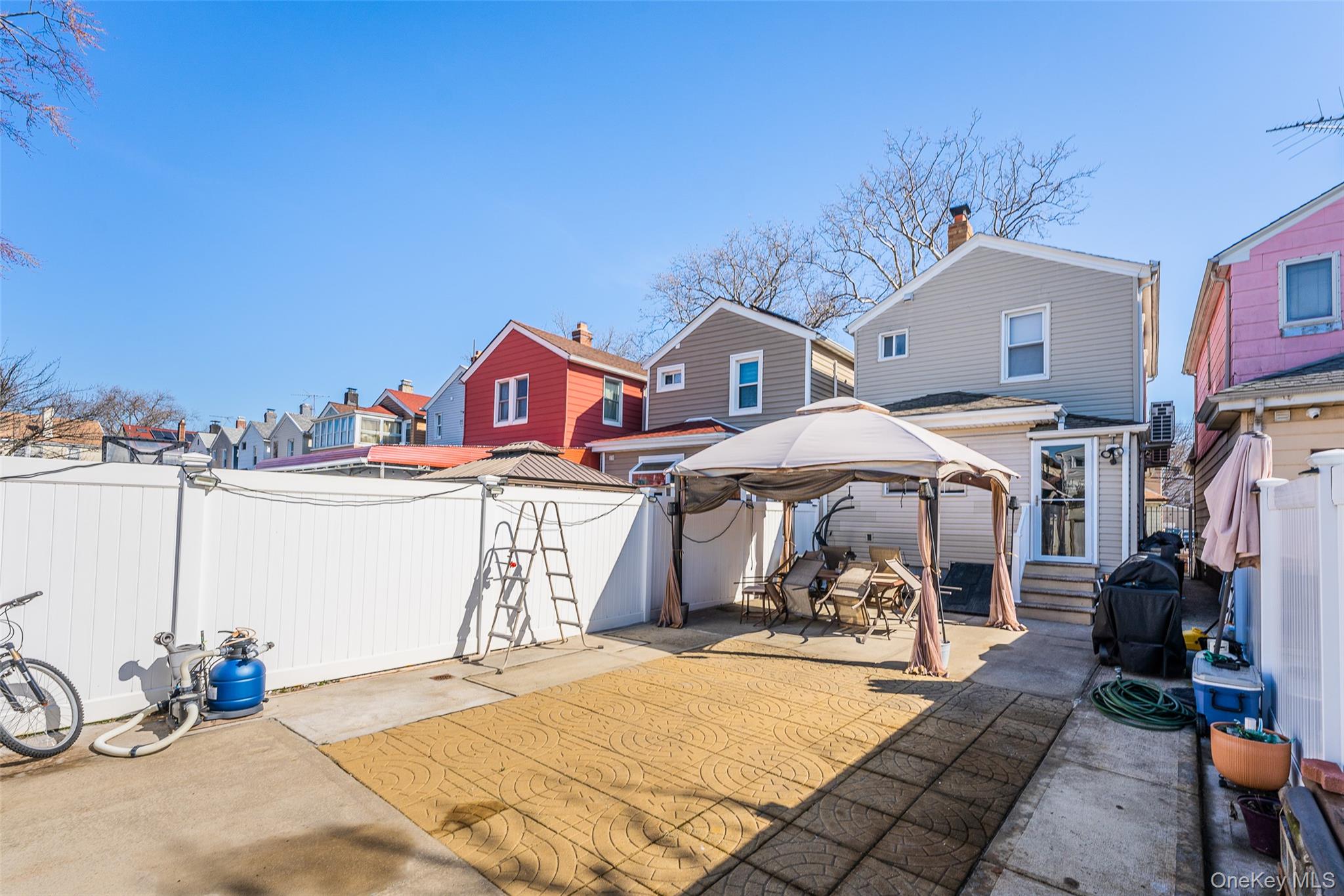 89-32 90th Street Queens, NY 11421 - Photo 20 of 33 Fenced backyard featuring a gazebo, a patio, a residential view, and grilling area